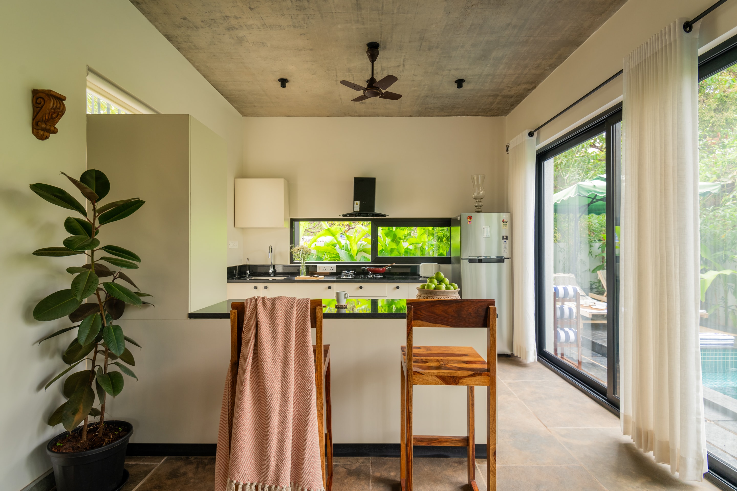 A light-filled kitchen opening onto a tropical garden