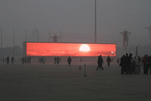 A glowing sunset installation in a public landscape